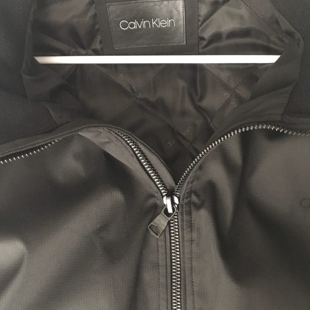 Black Calvin Klein (CK) bomber jacket.